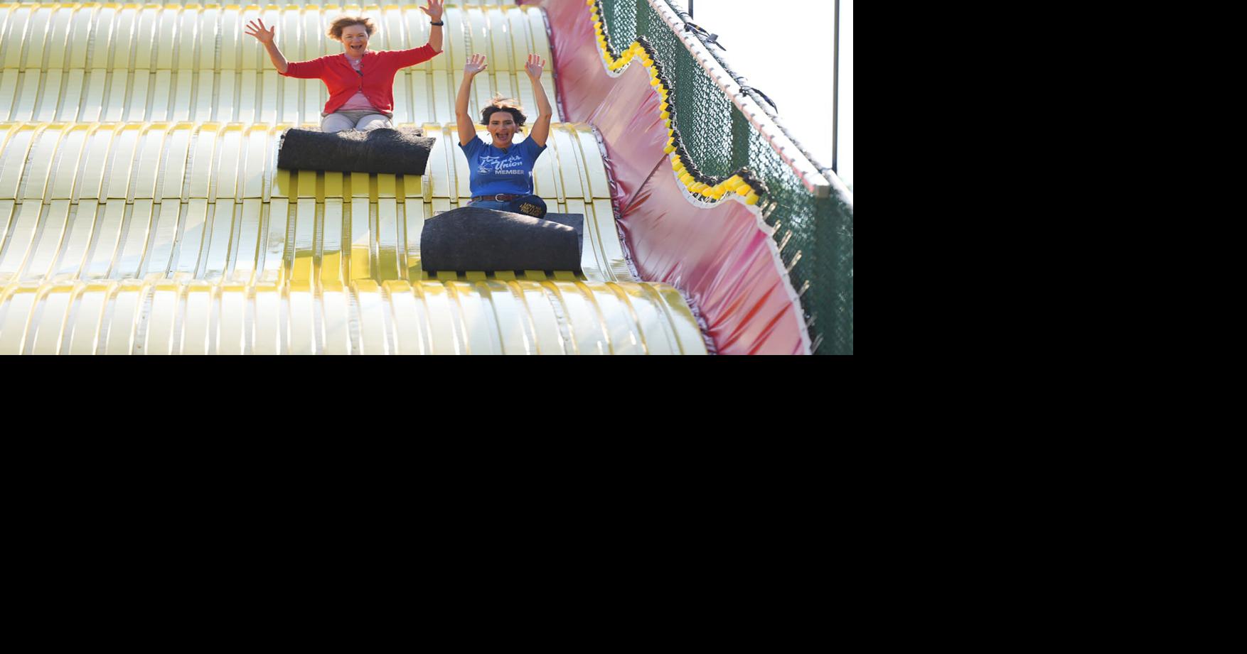 Peggy Flanagan, candidate for U.S. Senate, ride down the giant slide at the Minnesota State Fairgrounds on Aug. 27, 2026, in Falcon Heights, Minnesota.
