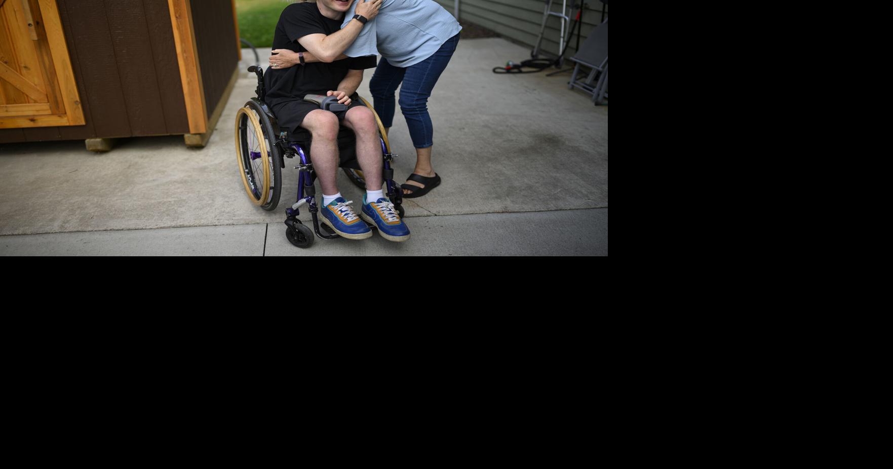 Mason Branstrator is embraced by his mother, Stacy Crawford, after Branstrator arrived home from getting a car repair Tuesday, Aug. 18, 2026, in Duluth, Minn..