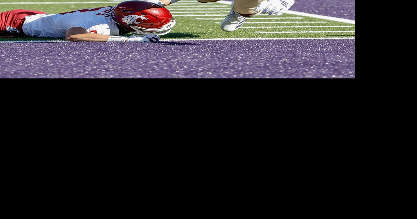 Washington's Rashid Williams scores on the 1- yard touchdown pass from Demond Williams Jr. in the fourth quarter as Washington State safety Jaylen Thomas defends at Husky Stadium in Seattle on Sunday, Sept. 6, 2026.