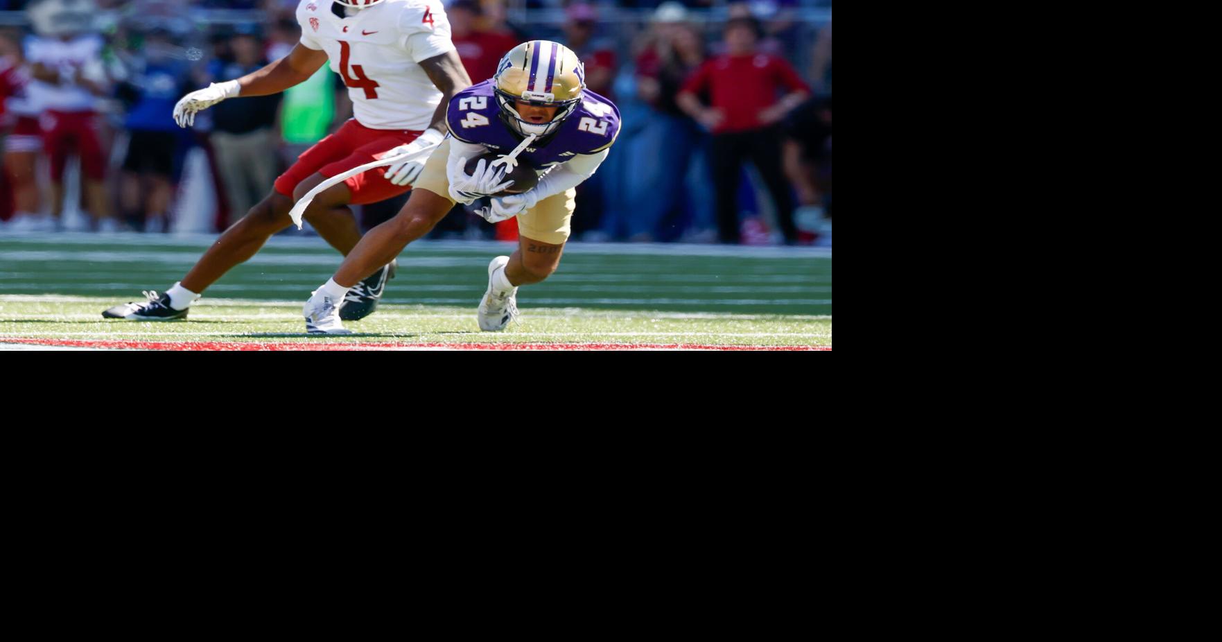 Washington Huskies cornerback Jeron Jones intercepts a pass intended for Washington State Cougars wide receiver Darrius Clemons during the second quarter Sunday, Sept. 6, 2026, at Husky Stadium in Seattle.