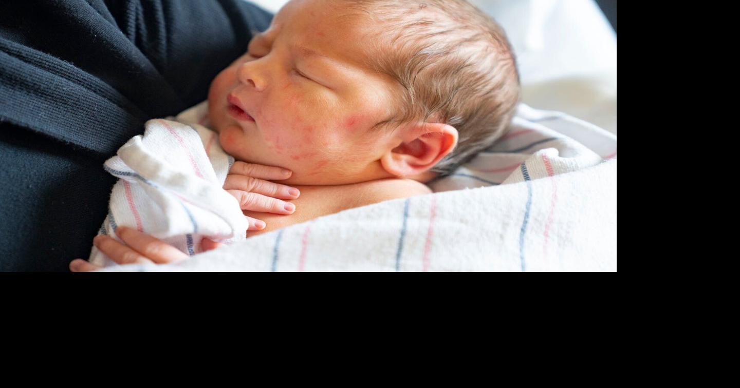 A newborn baby girl is held by her mother at Maple Grove Hospital in 2022.