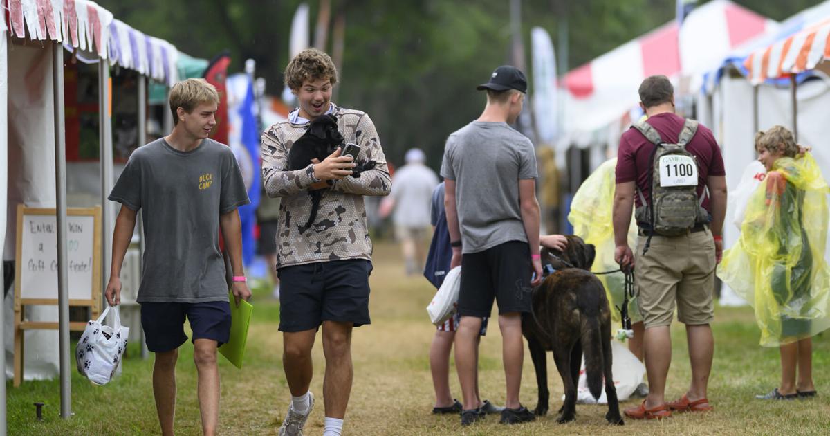 Holden Gilbertson, 17, of Delano, Minnesota, takes a selfie with his yet-to-be-named eight-week old black lab after buying it on Aug. 7, 2026, at Game Fair in Ramsey, Minnesota.