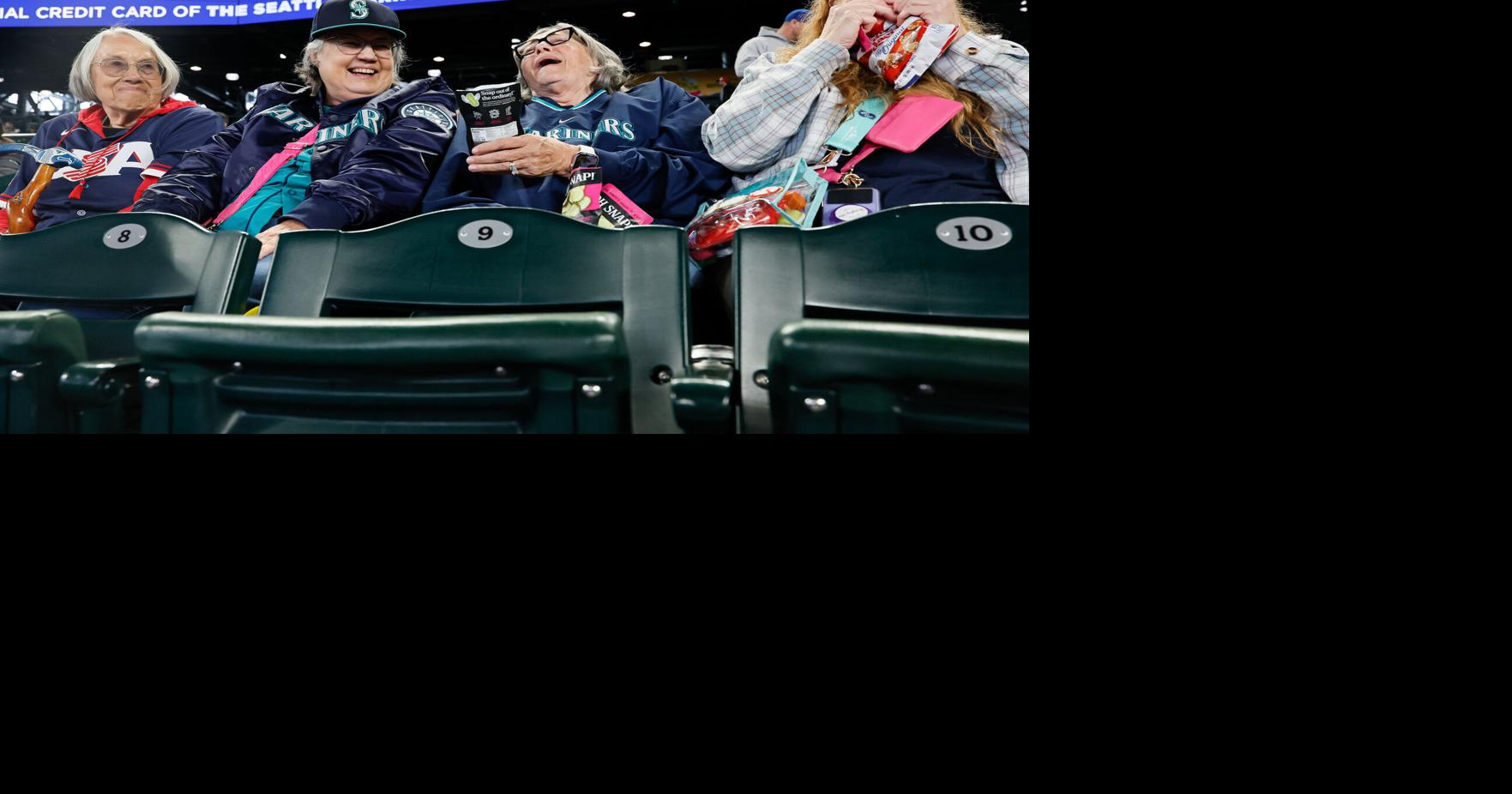 From left, Joan Staples- Morin, Rhenda Strub, Sheila Cook and Shirlene Hippensteel laugh with each other before the start of a game between the Seattle Mariners and the Athletics Wednesday, April 22, 2026, in Seattle. Strub, second from left, lost her son in 2023, the same year she became a Mariners fan. Hippensteel, at far right, is Strub’ s sister who is visiting for the...