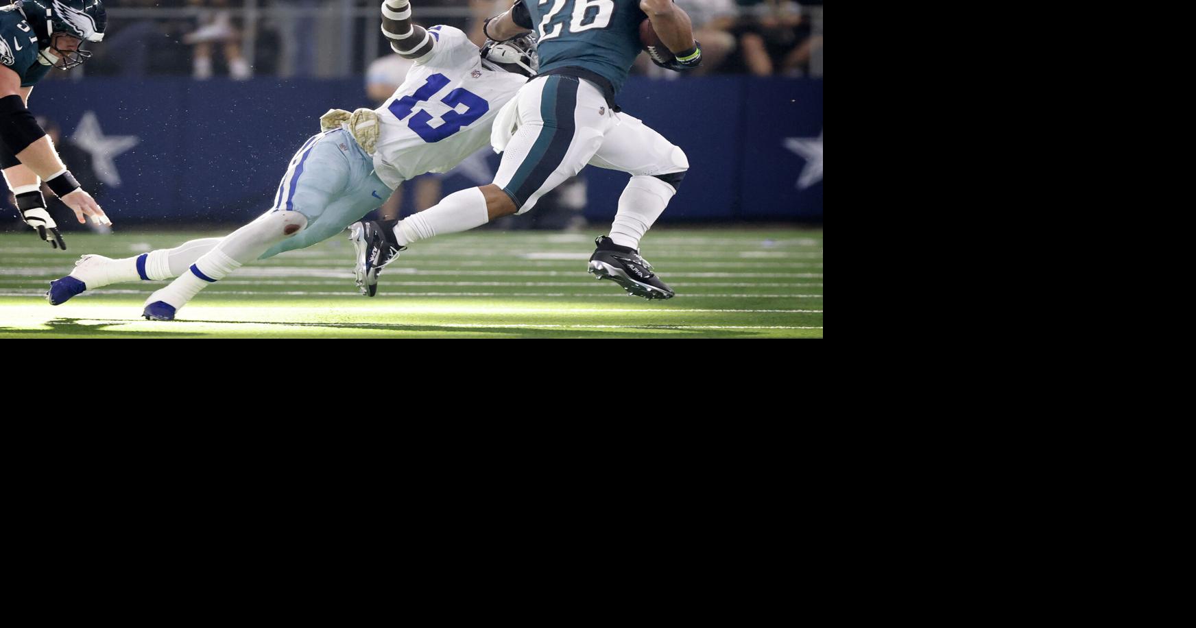 Philadelphia Eagles running back Saquon Barkley stiff-arms Dallas Cowboys linebacker DeMarvion Overshown on a second-quarter run at AT&T Stadium on Nov. 10, 2024, in Arlington, Texas.