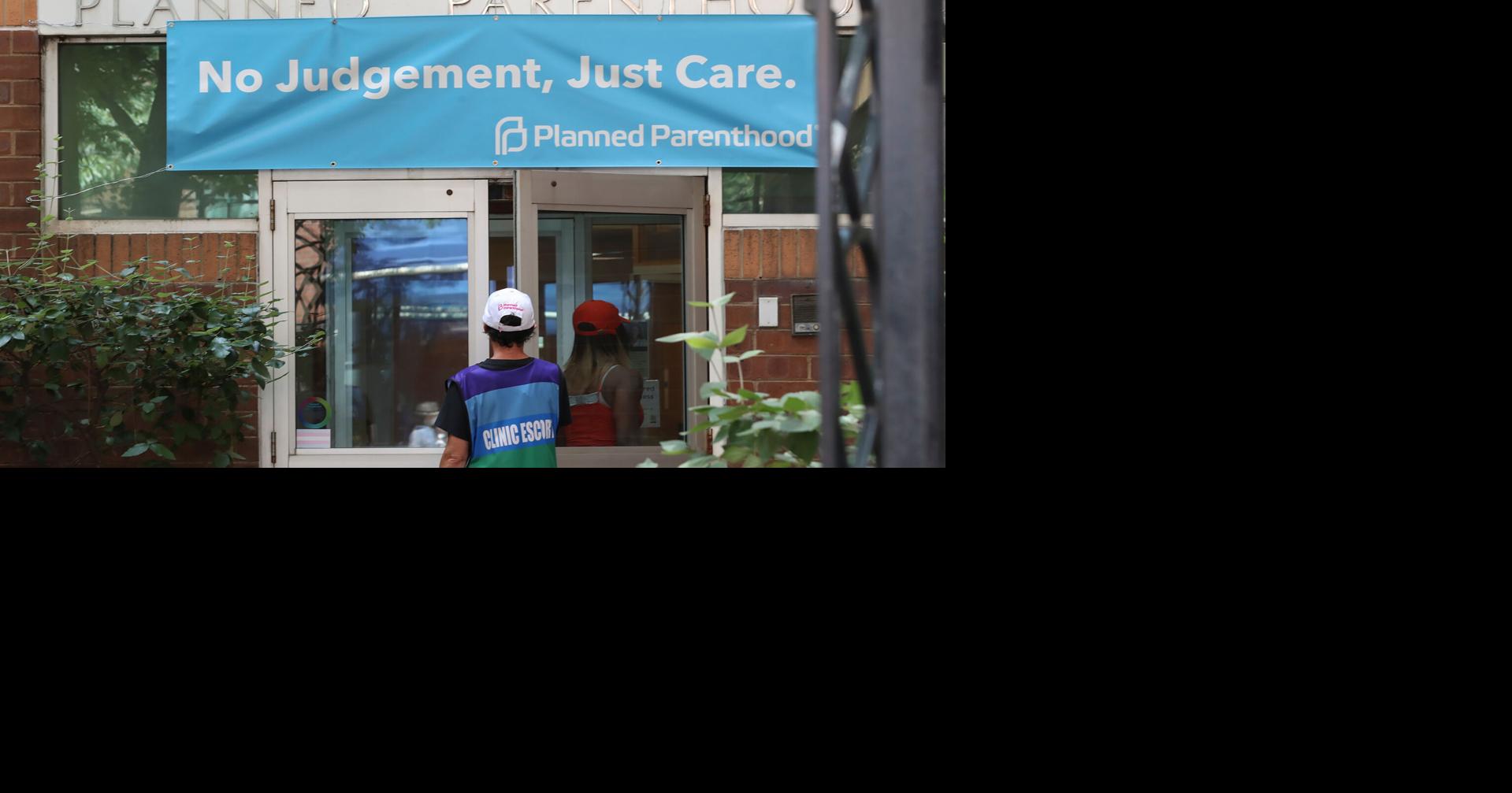A patient escort watches as a patient enters Planned Parenthood in Philadelphia's Center City neighborhood in 2022..