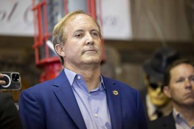 Attorney General Ken Paxton listens as his wife Sen. Angela Paxton thanks the crowd after winning her election on Tuesday, Nov. 8, 2022, at Haggard Party Barn in Plano, Texas. Angela Paxton was declared the winner for the Texas Senate District 8 seat ov...