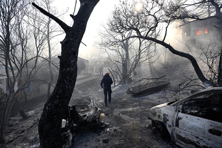 Firefighters battle massive wildfires in Belgium and Greece as 2 die on an island near Athens