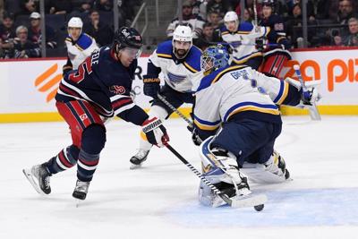 Jets soar past Blues as Hellebuyck nets shutout