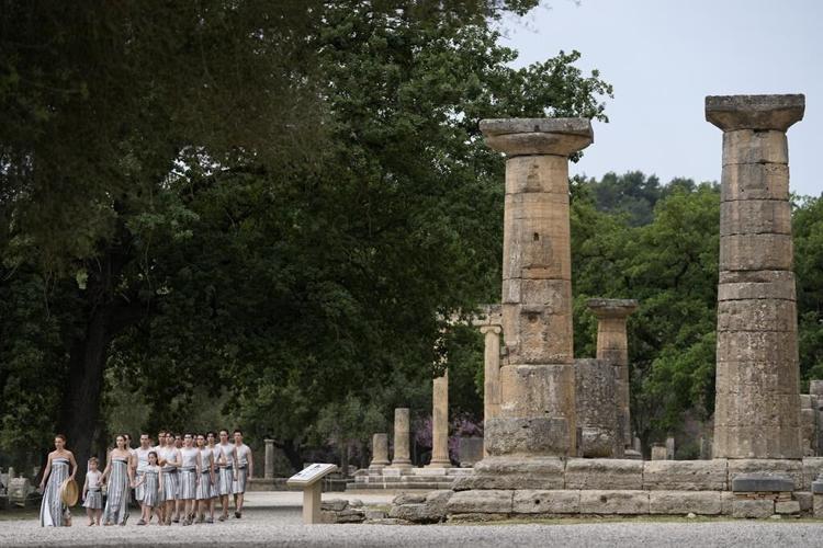 Despite weather glitch, the Paris Olympics flame is lit at the Greek cradle of ancient games