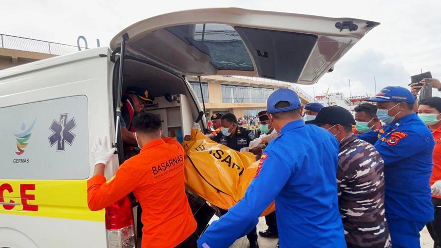 Indonesian rescuers find a body while searching for Spanish soccer coach and 3 children