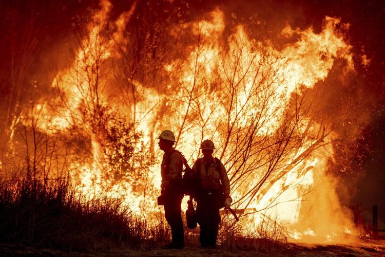 Firefighters hope for a break from fierce winds fueling devastating blazes in Los Angeles area