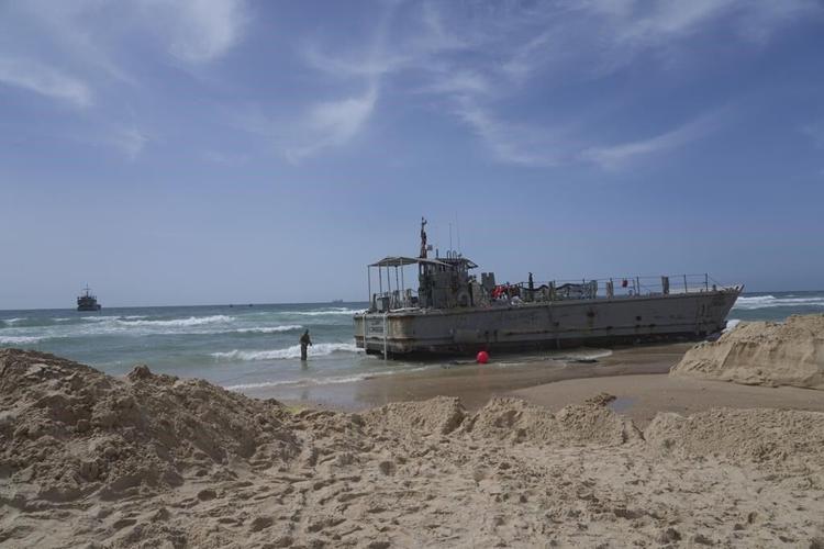 Aid deliveries suspended after rough seas damage US-built temporary pier in Gaza, US officials say