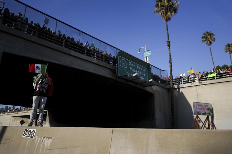 Marchers protesting planned deportations block major freeway in Los Angeles