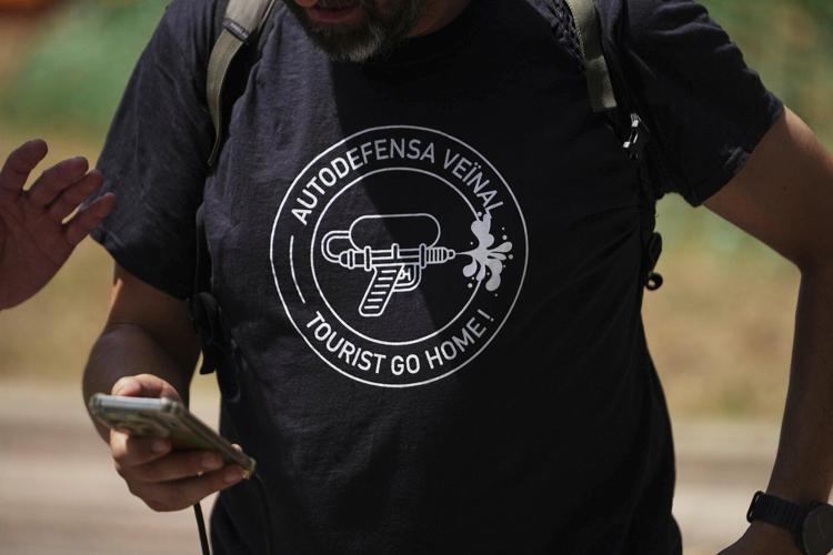 Spaniards turn water pistols on visitors in Barcelona and Mallorca to protest mass tourism