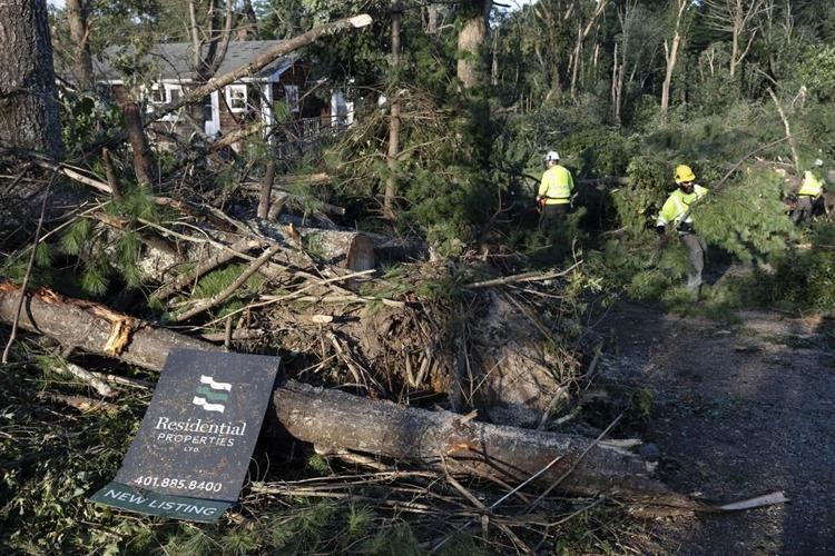 Rare New England tornado lifts car from a highway as strong storms damage homes and flood roads