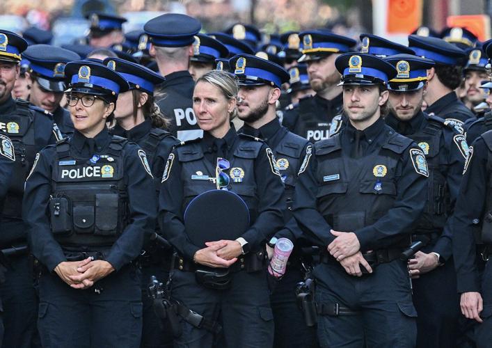 Police officers march in Montreal ahead of funeral for officer killed in shooting