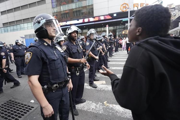 Crowd in the thousands overwhelms New York City's Union Square, tosses chairs, climbs on vehicles