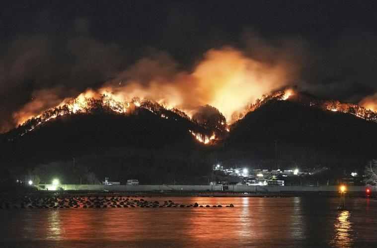 Japan fights a forest fire that has damaged dozens of homes and caused hundreds to evacuate