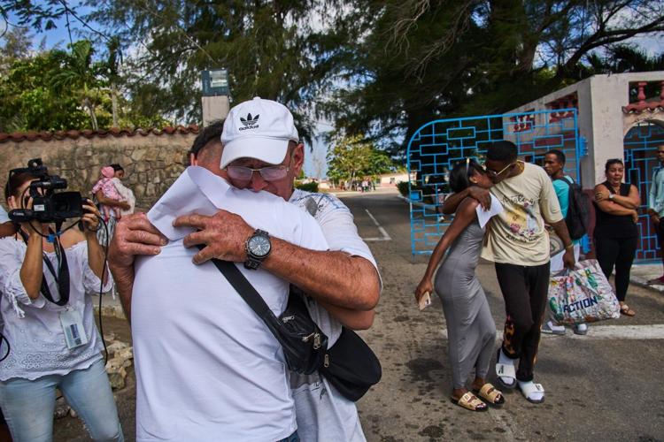Photos of freed prisoners reuniting with families outside a Cuban prison