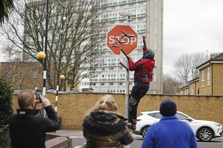 London police investigate the alleged theft of a Banksy stop sign decorated with military drones