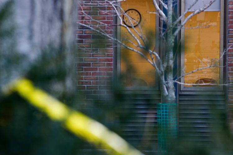Authorities knock on doors and seek evidence in the search for the Brown University shooter