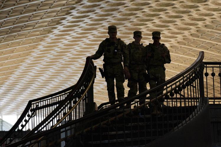 Photos of week three of Washington's federal takeover, as troops on patrol start carrying guns