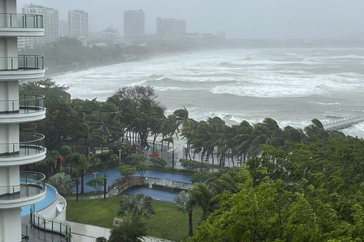 A typhoon heads for southern China after toppling trees on Hainan island