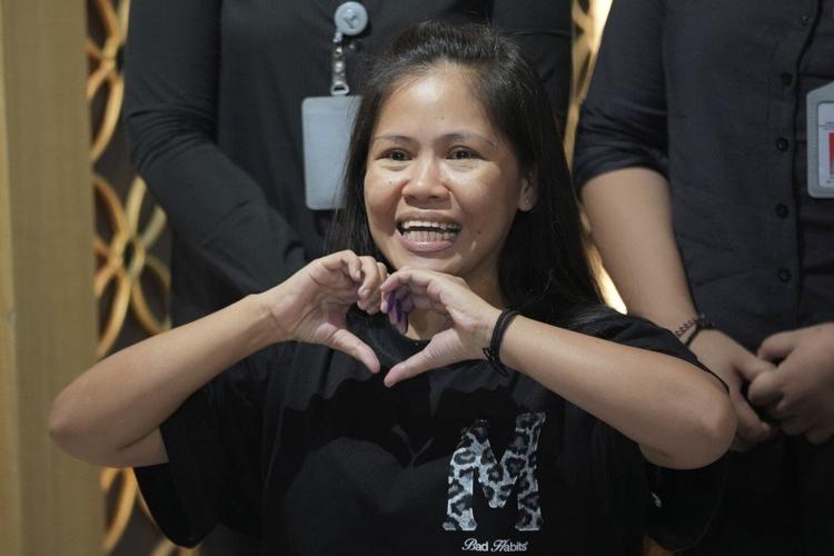 Filipina who won a last-minute reprieve from an Indonesian firing squad returns home