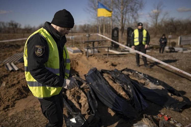 A year into Ukraine war, bodies dug up in once occupied town