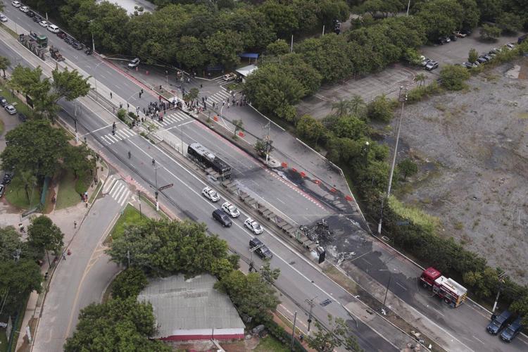 A small plane loses altitude after takeoff and slams into a Sao Paulo avenue, killing 2 passengers