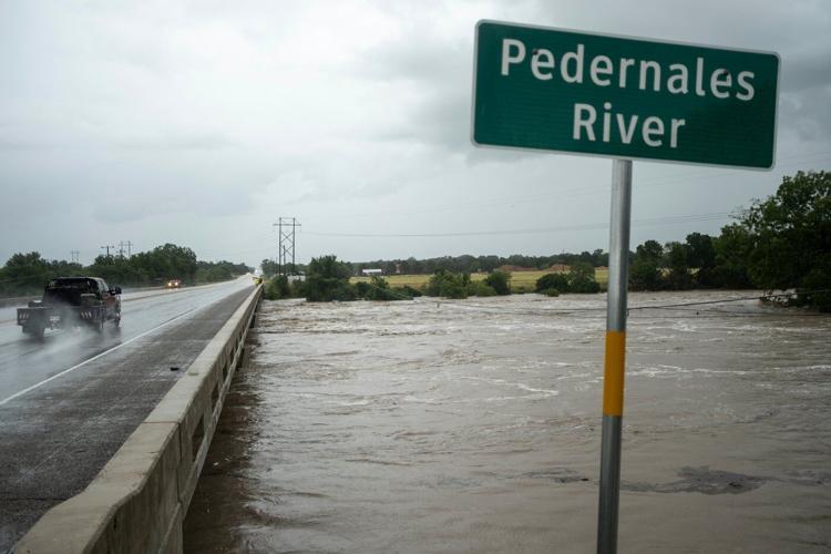 Texas flooding surges from huge rainstorms as rescuers pull people from rising waters