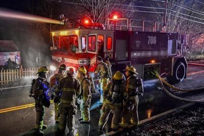 Truck carrying gas hits railroad bridge and explodes as a train passes overhead