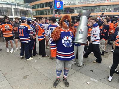 Edmonton Oilers superfans cross ocean, paint body in blue and orange to watch games