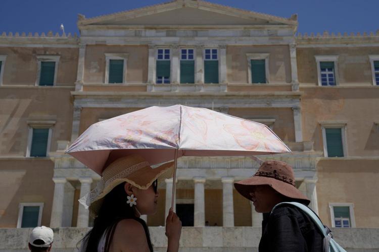 The sunhat is everywhere in Athens as crowds grow larger at ancient sites