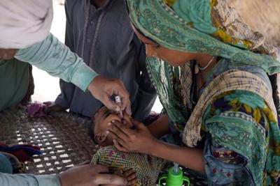 Gunmen kill a police officer assigned to protect polio workers in Pakistan’s northwest