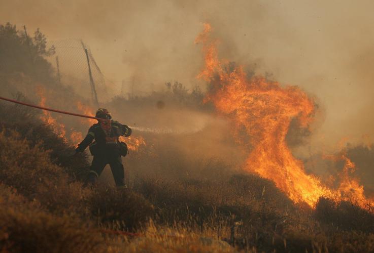 Firefighters race to contain wildfires in Greece as thousands evacuated, 2 die in Turkey