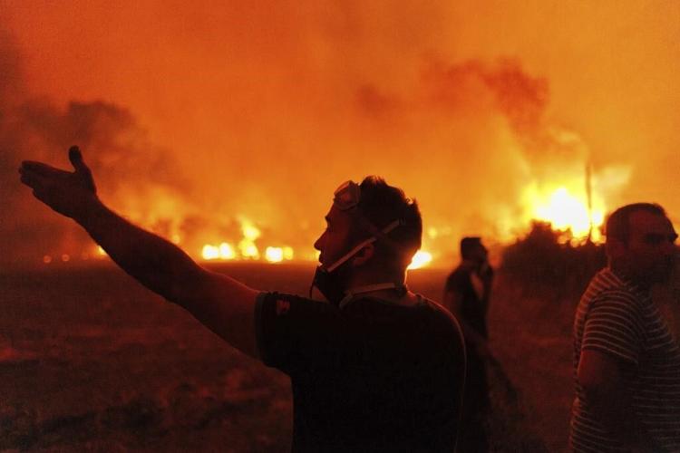 A major wildfire in northeastern Greece has forced the evacuation of villages and a city hospital