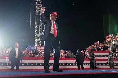 A man arrested with guns outside a Trump rally in California is suing the sheriff