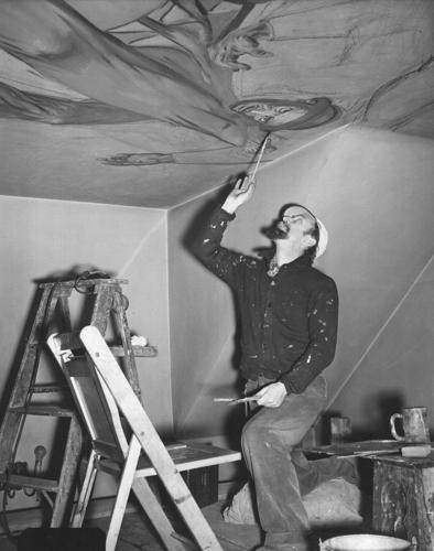 Inside a historic church painted with murals that reflect searing social commentary