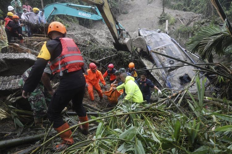 Landslide triggered by rain in Indonesia's Sumatra island kills 9 people in a tourist bus