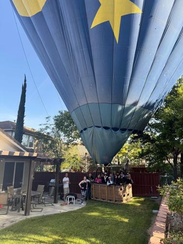 Mind if we drop in? Hot air balloon with 13 aboard makes emergency landing in California backyard