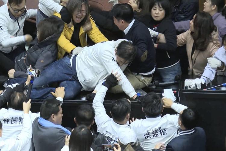 Taiwan lawmakers clash after one party breaks into legislature to occupy speaker's chair