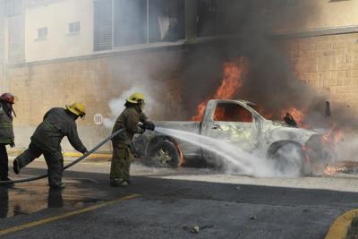 Protesters in southern Mexico set state government building afire and torch a dozen vehicles
