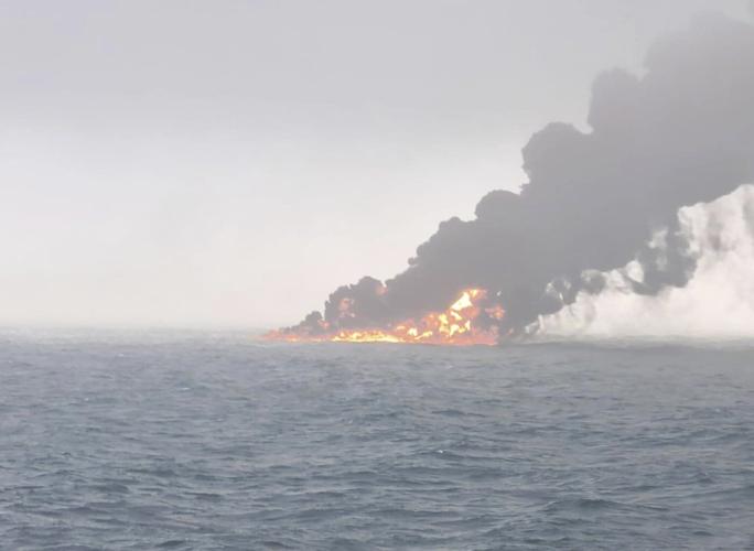 A cargo ship hits a tanker and they catch fire off England. The crew members are safe