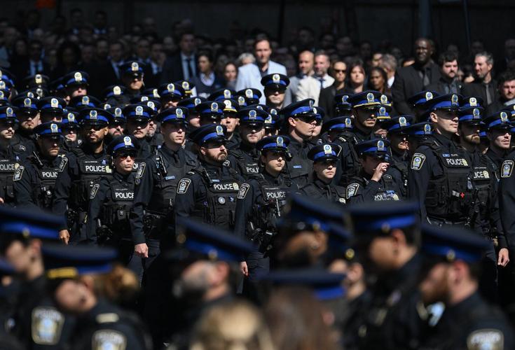 Police officers march in Montreal ahead of funeral for officer killed in shooting