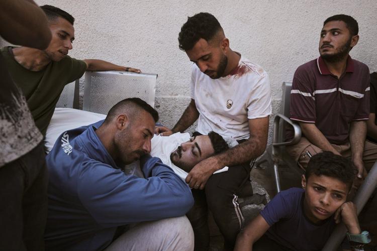 Photos show people mourning after airstrikes and shooting in Gaza overnight