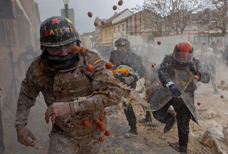 Photos show flour, eggs and firecrackers flying at Spain's Els Enfarinats festival