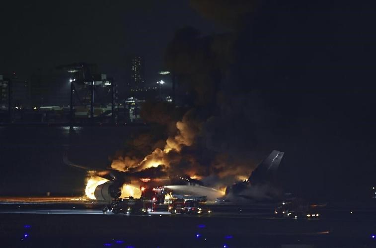 Plane catches fire on runway at Japan's Haneda airport after collision, passengers reportedly safe
