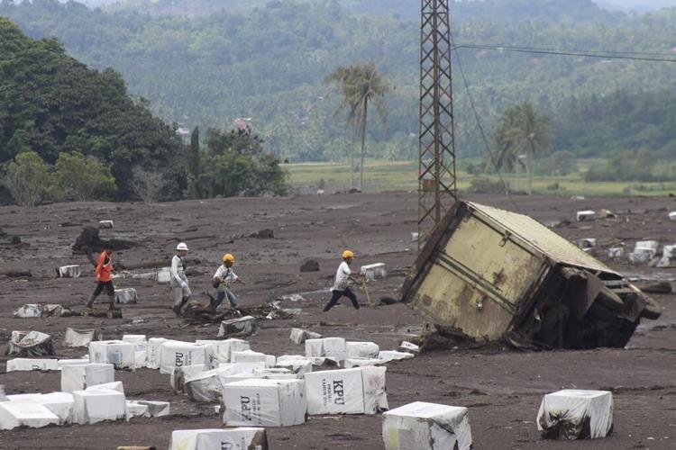 Indonesian rescuers search through rivers and rubble after flash floods that killed at least 50