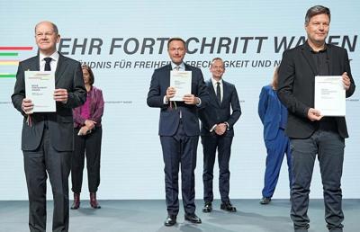 Members of Germany's smallest governing party vote to stay in Scholz's coalition, prompting relief